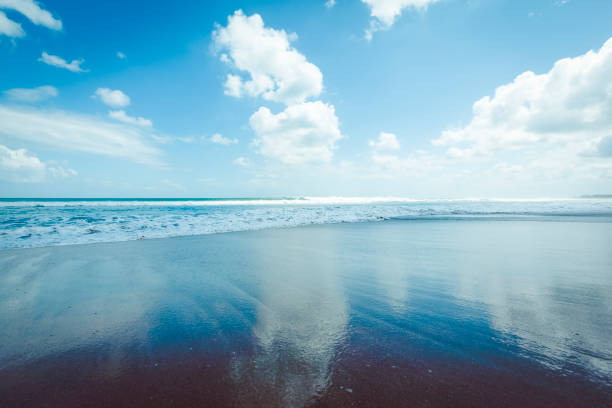 A woman is walking on beach after swimming.Sanur beach - Bali Island - Indonesia.