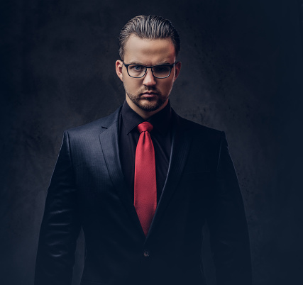 Portrait Of A Stylish Male In A Black Suit And Red Tie Isolated On A Dark  Background Stock Photo - Download Image Now - Istock
