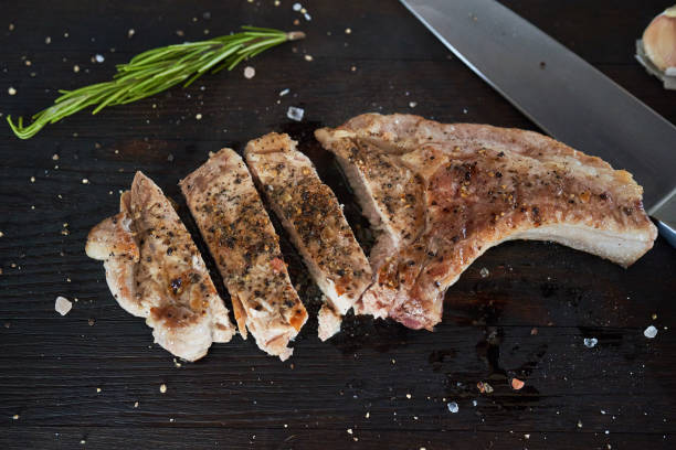 istock Pork fried loin steaks on black table 1026735988