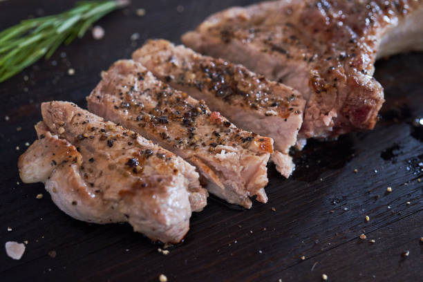 istock Pork fried loin steaks on black table 1026738092