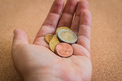 money and finances concept - Male hands holding euro coins