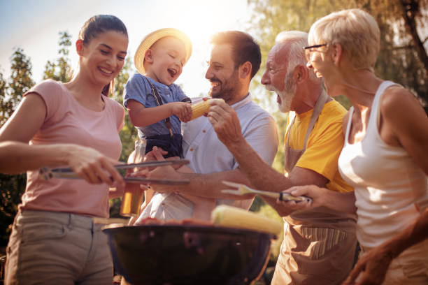 istock Happy family having barbecue party in backyard 1026746614