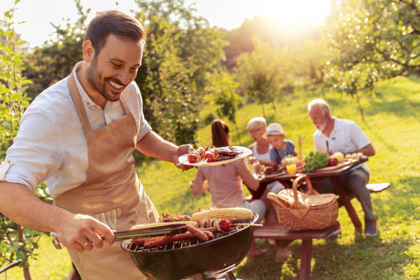 Happy big family having lunch at summer garden party Happy family having barbecue party in backyard.Food,family,fun and happiness concept. grilled stock pictures, royalty-free photos & images