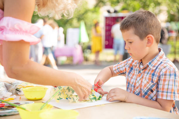 istock Cute little boy cutting shapes out of colored paper. Being creative, developing imagination, creativity, do it yourself concept 1026747548