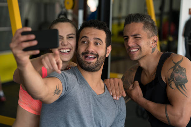 istock Friends watching the cell phone in the gym 1026750048