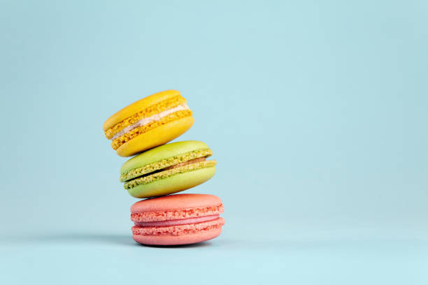 istock Colorful cake macaron or macaroon on blue pastel background. Different types of macaroons. 1026750392