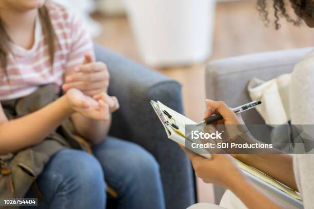 Mental Health Professional Takes Notes During Session Stock Photo - Download Image Now