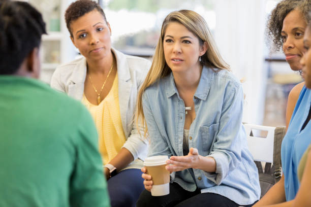 istock Counselor gives advice during group therapy session 1026754464