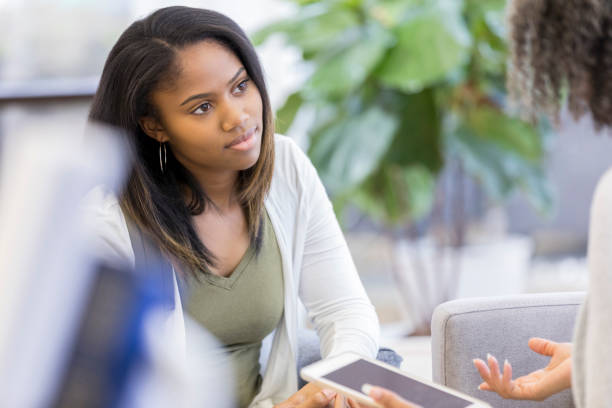 istock Attentive teenager talks with counselor 1026754502