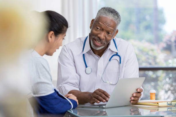 istock Confident African American doctor talks with patient 1026754602