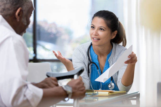 istock Serious doctor talks with injured patient 1026754666