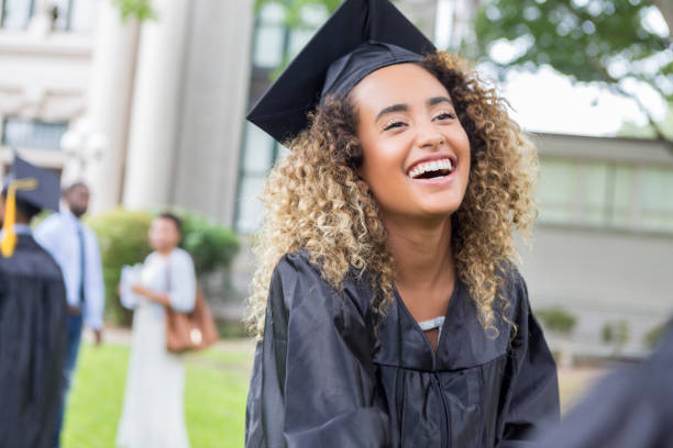 istock Happy college graduate talks with friend 1026754746