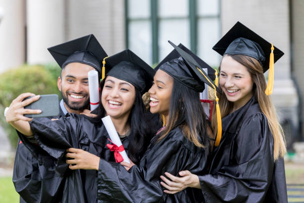 istock Group of graduates taking selfie 1026754786