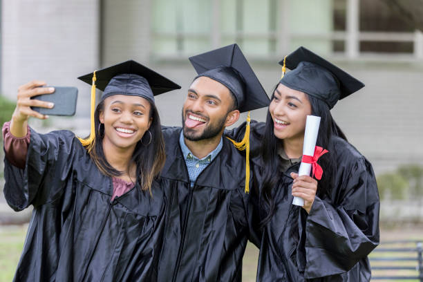 istock Playful college graduates taking selfie 1026754790