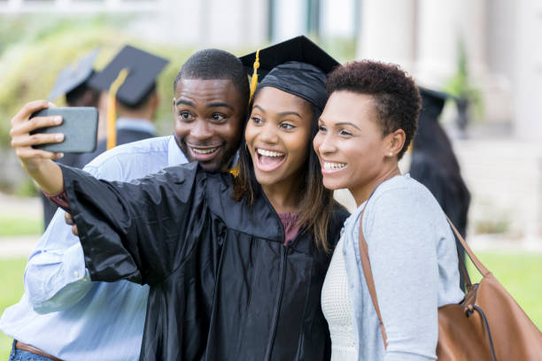 istock College grad takes selfie with parents 1026754804