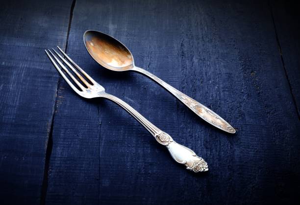 istock vintage fork and spoon. On Wooden background. Top view. 1026755706