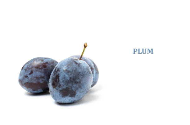 Plums and yellow apples close-up in a plate