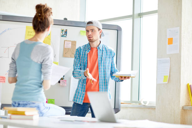 istock Pensive guy arguing with colleague in office 1026774274