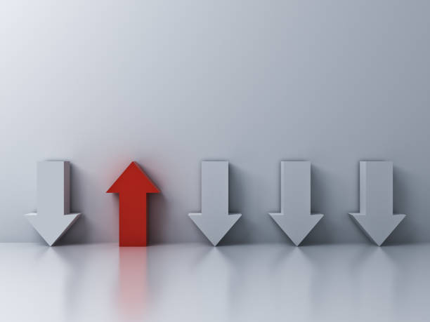istock Stand out from the crowd and different concept One red up arrow among other down arrows on white wall background with reflections and shadows 3D rendering 1026781028