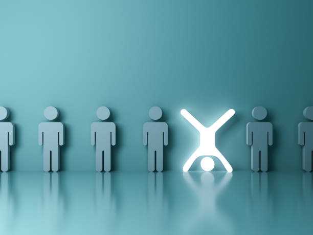 istock Stand out from the crowd and different creative idea concept One glowing light man standing upside down with arms and legs wide open among other people on dark green background 3D rendering 1026781048