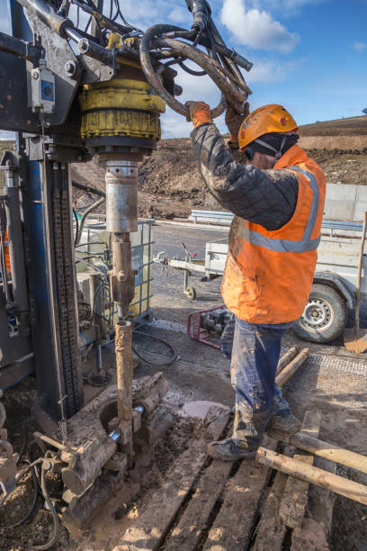 drilling worker examining drilling rig - borehole imagens e fotografias de stock