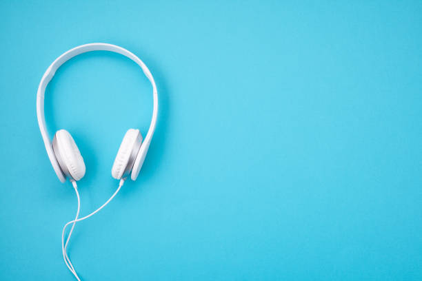 White earphones on blue background. Minimal style picture