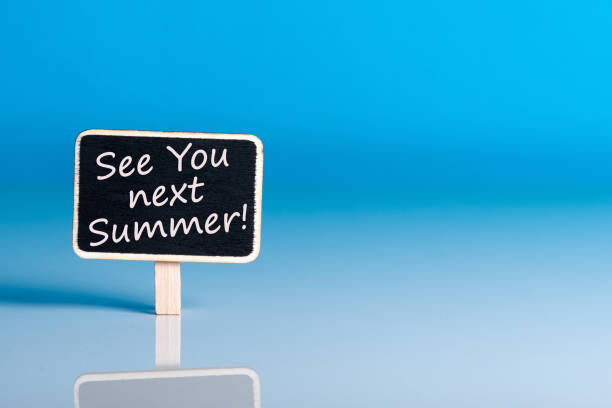 istock See you next Summer written on a note at the office table with empty space for text 1026787076