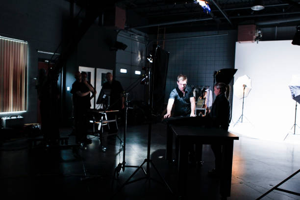 istock People Working Behind the Scenes while Filming on a Film Set 1026791646