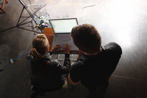 People Working on a Laptop Behind the Scenes on a Film Set