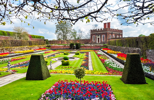 London, UK - circa april 2018: Hampton Court gardens (royal residence of british monarchs built in 16-17 century) in spring in Richmond upon Thames near London