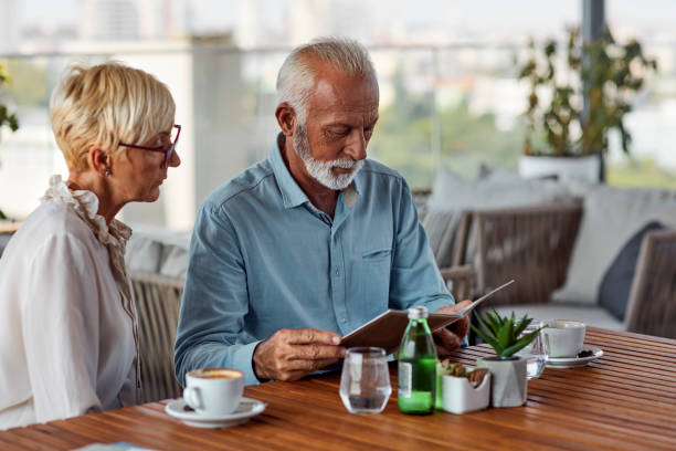 istock Senior Couple In Restaurant Ordering Food 1026796924