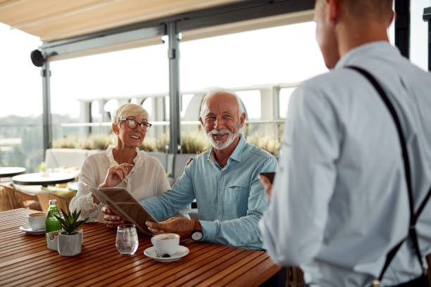 istock Senior Couple In Restaurant Ordering Food 1026797014