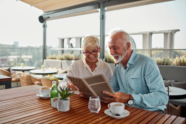 Senior Couple In Restaurant Ordering Food