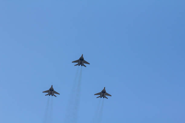 istock Several military fighters are flying in a formation against the blue sky 1026799424