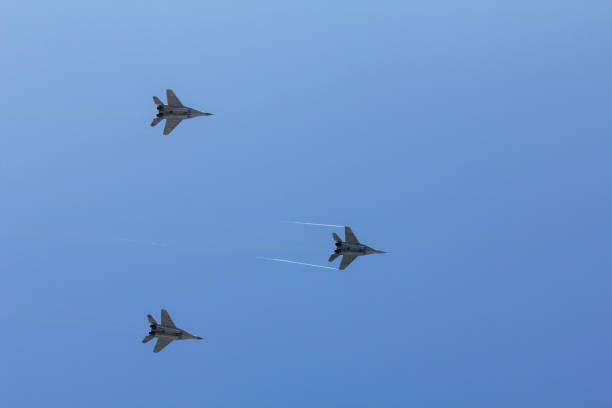 istock Several military fighters are flying in a formation against the blue sky 1026799446