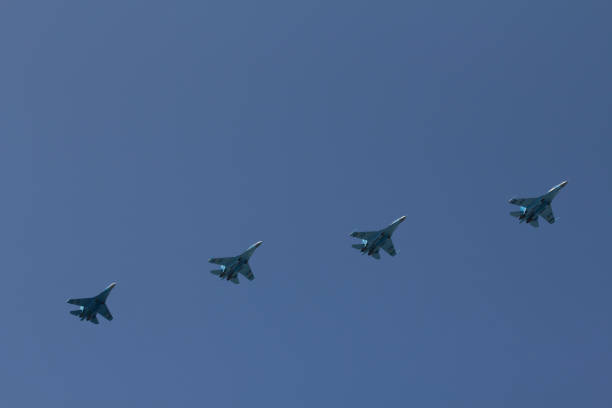 istock Several military fighters are flying in a formation against the blue sky 1026799448