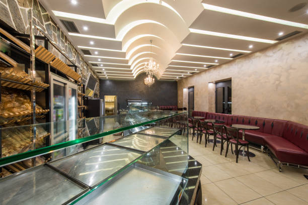 istock Bakery cafe restaurant interior, empty seats and glasses shelves 1026799758