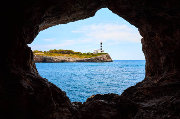 istock Portocolom Lighthouse on a cliff seen from a cave. 1026800132