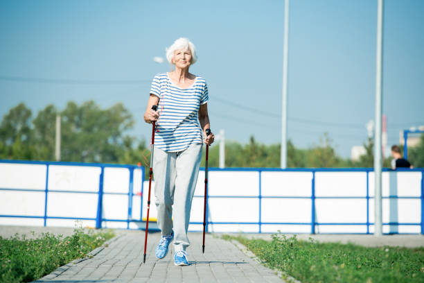 istock Happy Senior Woman Nordic Walking 1026803378