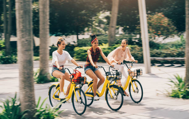 istock Carefree girlfriends enjoying biking and having fun 1026807096