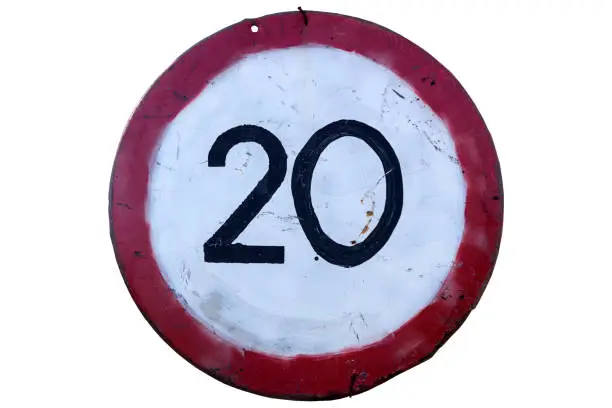 Old handmade road sign 'Speed limit 20' isolated on white.