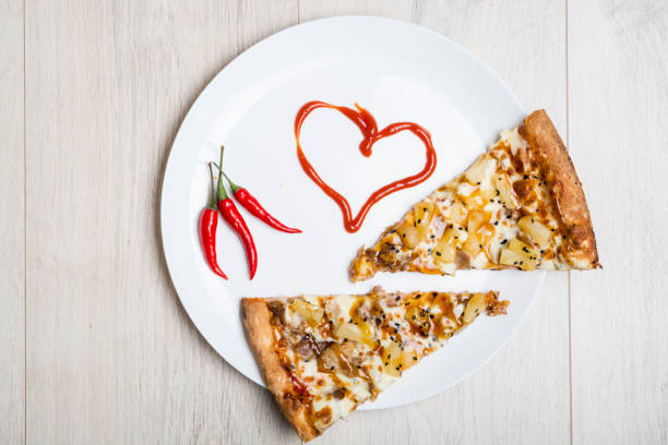 istock Two slices of pizza and ketchup heart 1026817272
