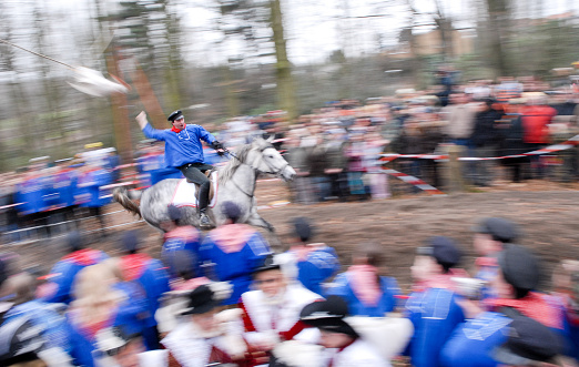 Wattenscheid, Germany - February 19, 2007: A horse rider speeds around the racing track in a local 'goose riding' competition concluding the carnival celebrations at city of Wattenscheid in Western Germany. The riders attempt to decapitate a dead goose. Whoever rips off the head first will become next year's carnival price.
