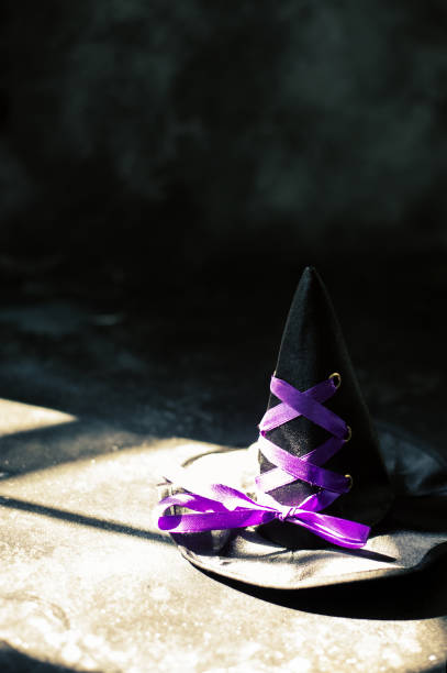istock Witch hat on dark table. Halloween holiday concept 1026834090