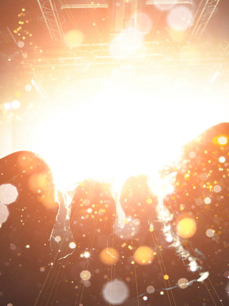 Close up on a handheld smart phone, recording a live gig. Background is a defocused stage.