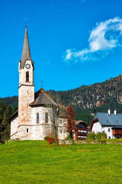 istock Mountains over Gosau village with Catholic Church under Sunlight 1026843096