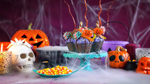 istock Halloween candyland drip cake style cupcakes in party table setting 1026843272