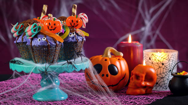 istock Halloween candyland drip cake style cupcakes in party table setting 1026843294