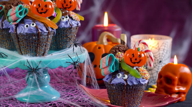 istock Halloween candyland drip cake style cupcakes in party table setting 1026843324