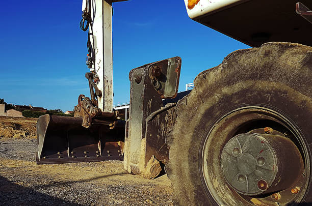 istock Heavy earthmover construction machine is leveling sand at building site. 1026843572
